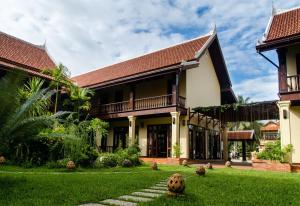 a house with a halloween pumpkin in the yard at Sada Hotel in Luang Prabang