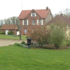 een huis met een vogelbad in de tuin bij La maison d'amis in Auneuil