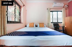 a bedroom with a large bed in a room at Gods gift guesthouse in Arambol