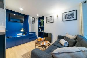 a living room with a couch and a table at Architect's Duplex - Haut Marais in Paris