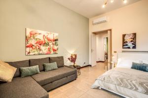 ein Wohnzimmer mit einem Sofa und einem Bett in der Unterkunft Borghese Green in Rom