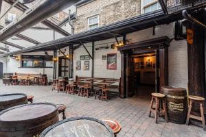 a patio with tables and stools and wooden tables at O'Donoghue's in Dublin