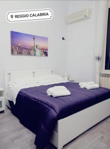 a bedroom with a bed with a purple blanket at B&B Metropolitan RC in Reggio di Calabria