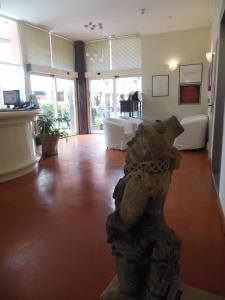 a living room with a bear statue in the middle at Hotel San Giorgio in Bologna