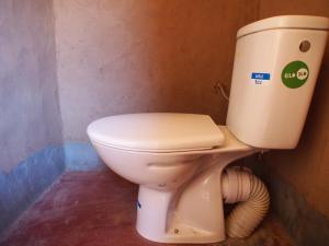 a bathroom with a toilet in a room at sahara desert camp tours in Zagora