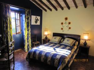 a bedroom with a bed and two lamps and a window at La Frandomière in Saint-Martin-de-Londres