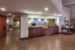 a lobby with a bar in the middle of a building at Holiday Inn Express & Suites Carpinteria, an IHG Hotel in Carpinteria