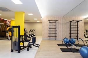 a gym with treadmills and elliptical machines at 360 Suítes Sé in Sao Paulo