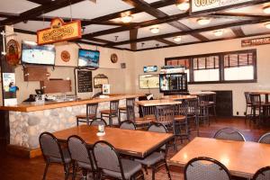a restaurant with tables and chairs and a bar at The Drake Inn in Canmore