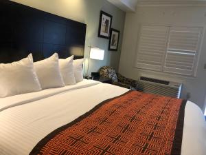 a hotel room with a large bed with white pillows at Seaside Inn in San Francisco
