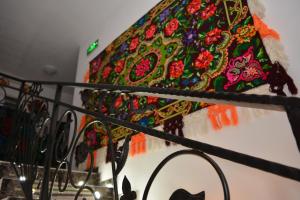 a colorful umbrella is sitting on top of a rail at Pensiunea Vraja in Giuleşti