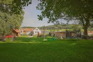 a yard with a playground with a swing at U Svatého Petra in Kájov