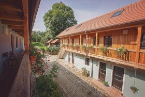 an old building with a balcony with flowers on it at U Svatého Petra in Kájov