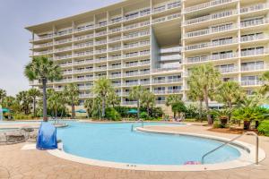 a swimming pool in front of a large building at Sterling Shores in Destin