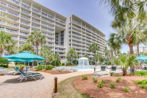 a large apartment building with a pool and palm trees at Sterling Shores in Destin
