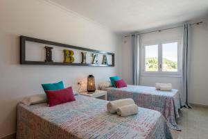 A bed or beds in a room at Villa Views Can Funtasa II