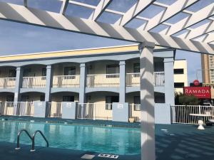 a view of a hotel with a swimming pool at Ramada by Wyndham Virginia Beach in Virginia Beach
