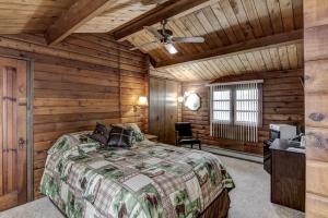 a bedroom with a bed in a room with wooden walls at Rib Waters Inn in Rib Lake