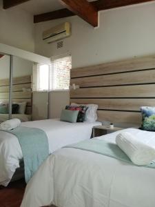 a bedroom with two beds and a mirror at San Lameer Villa 3103 in Southbroom