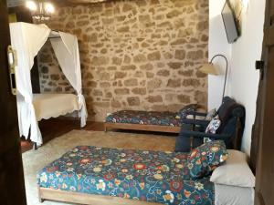 a living room with a bed and a couch at La Bodeguita in Cuzcurrita-Río Tirón