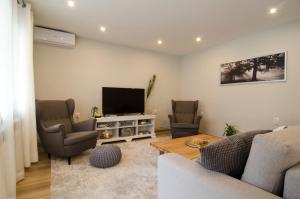 a living room with a couch and a tv at Salam Sarajevo Apartments #HelloPeace in Sarajevo