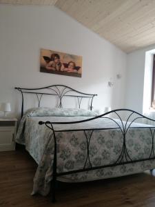a bedroom with a bed with a metal frame at La Casina in Clusone