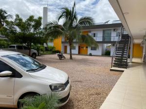 a white car parked in front of a house at Rossi Hotel in Comodoro