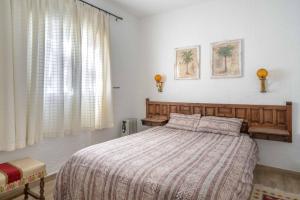 a bedroom with a large bed and a window at La "Casita" de la Sierra in Guadarrama +33 photos