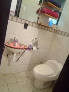 a bathroom with a toilet and a sink at Casa Santuario Hotel Boutique in Guadalajara