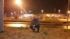 a man sitting on the side of a bridge at night at STANZA Juventus, con servizio navetta a richiesta in Turin