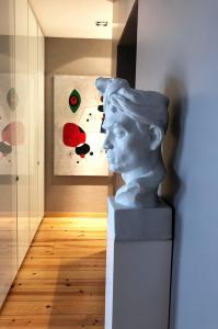 a statue of a bust in a room with a painting at Apartment by the Sea in Porto