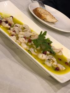 a dish of food on a plate on a table at Hotel Sarajet e Pashait 1 in Dhërmi