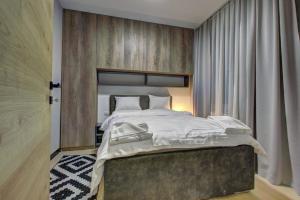 a bedroom with a large bed in a room at Apartment A17 LUX in Jahorina