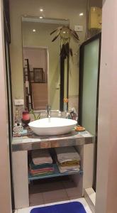 a bathroom with a sink and a large mirror at Skylab Guesthouse in Manila