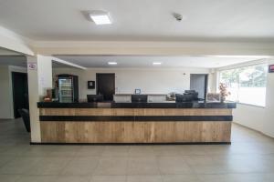 an empty lobby with a counter in a building at Hotel Guarumar in Guarujá