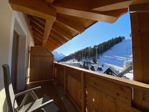 a balcony with a view of a ski resort at Boutique Hotel Diana in Madonna di Campiglio