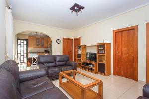 a living room with a couch and a table at CH Villa Isla Espalmador Ciudad Quesada in Ciudad Quesada