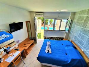 a room with a bed with a teddy bear on it at Porto Evia Boutique Hotel in Amarinthos