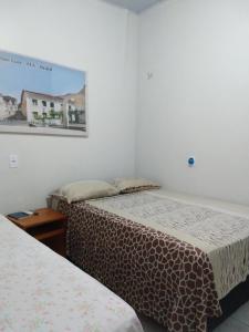 Un pat sau paturi într-o cameră la Pousada Jatobá