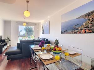a living room with a glass table and a couch at Sea N' Sun Apartment by LovelyStay in Ribeira Brava