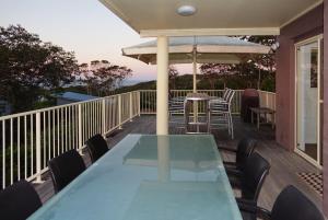 a deck with a table and chairs and an umbrella at At Cylinder Unit 3 in Point Lookout