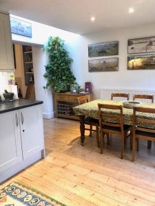 a kitchen and dining room with a table and chairs at Lauras Townhouse Apartments Thomas Street Townhouse in Bath