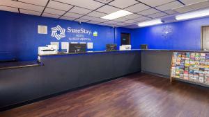 an empty office with a blue wall and a counter at SureStay Hotel by Best Western Phoenix Airport in Phoenix