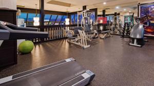 a gym with treadmills and balls and machines at Seven Oaks Hotel Regina in Regina