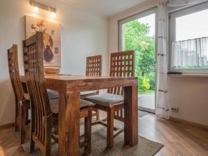 a dining room with a wooden table and chairs at Naturferienhaus mit Schlossblick in Drübeck in Drübeck