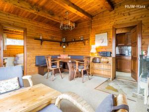 a living room with a table and a kitchen at Haus am Hang in Bad Lauterberg