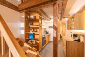 a kitchen with wooden stairs in a house at Villa-Duck-Dich 27 in Wernigerode