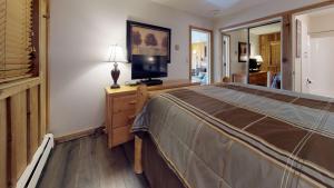 a bedroom with a bed and a television on a dresser at Vail 21 - CoralTree Residence Collection in Vail