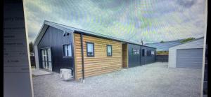 a row of houses in a yard with a sky at Central Retreat and self contained with free wifi in Cromwell
