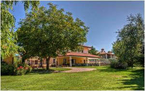 ein Haus mit einem Baum im Hof in der Unterkunft Hotel Pesek in San Dorligo della Valle